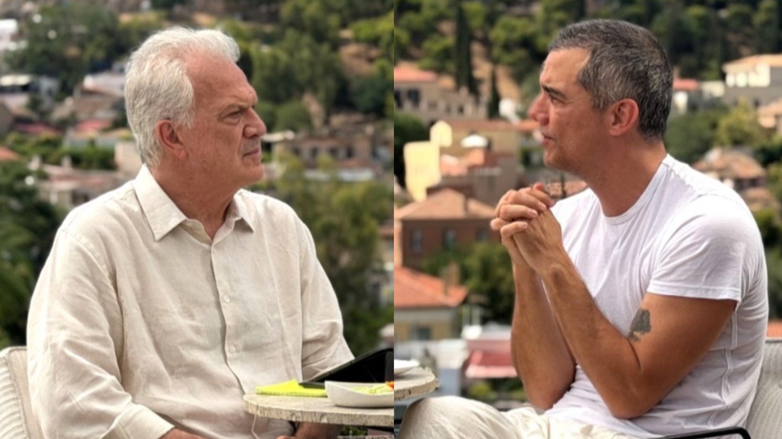 Pedro Bial e Wagner Moura sentados a uma mesa com Atenas ao fundo