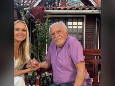 Eliana e Ary Fontoura de mãos dadas, sorrindo, no jardim do casarão dele no Recreio dos Bandeirantes